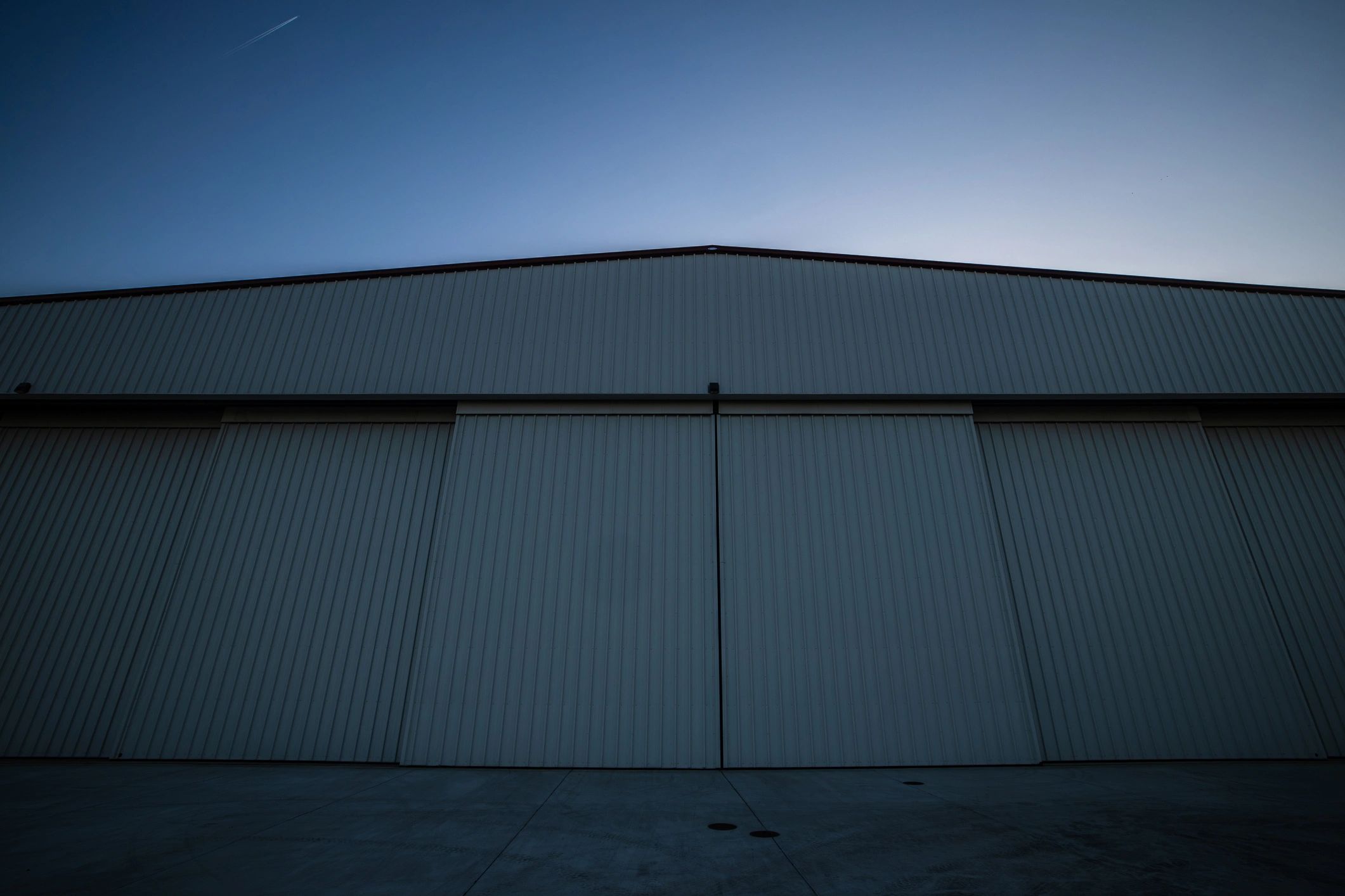 Aircraft hangar at sunset